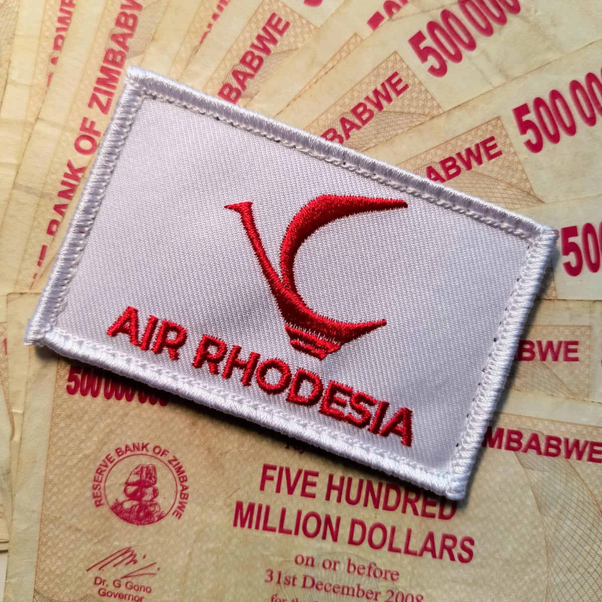 Air Rhodesia patch on top of Zimbabwean banknotes